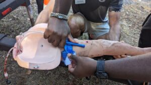 CERT members applying a tourniquet to an arm to simulate bleeding control practices