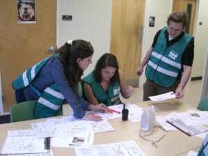 Three CERT members at a table discussing how to proceed